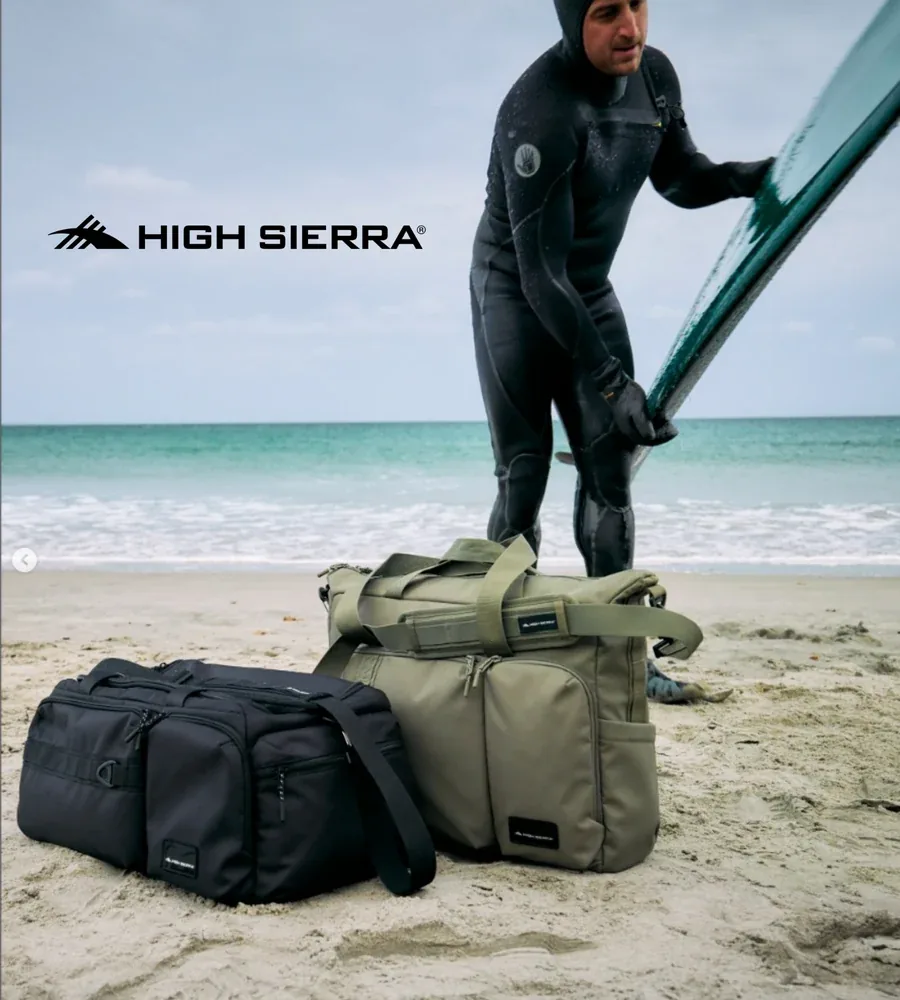 High Sierra campaign featuring a surfer and travel bags on a beach