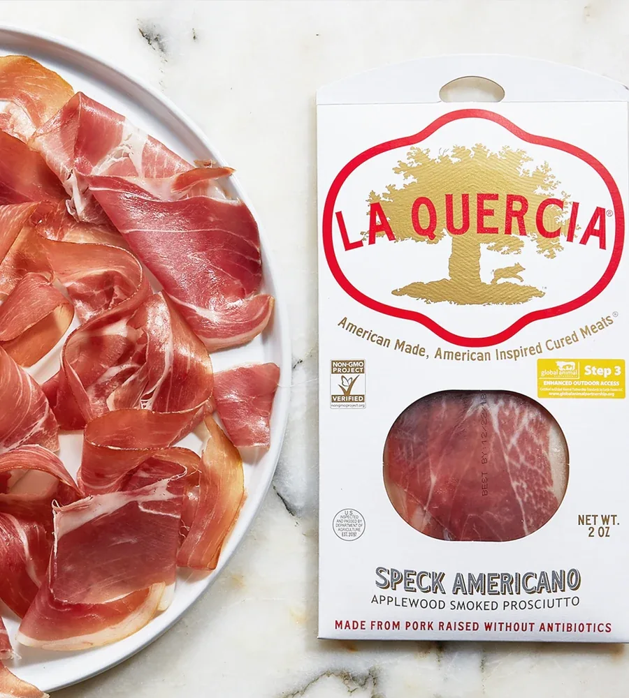 La Quercia Speck Americano packaging beside a plate of sliced prosciutto