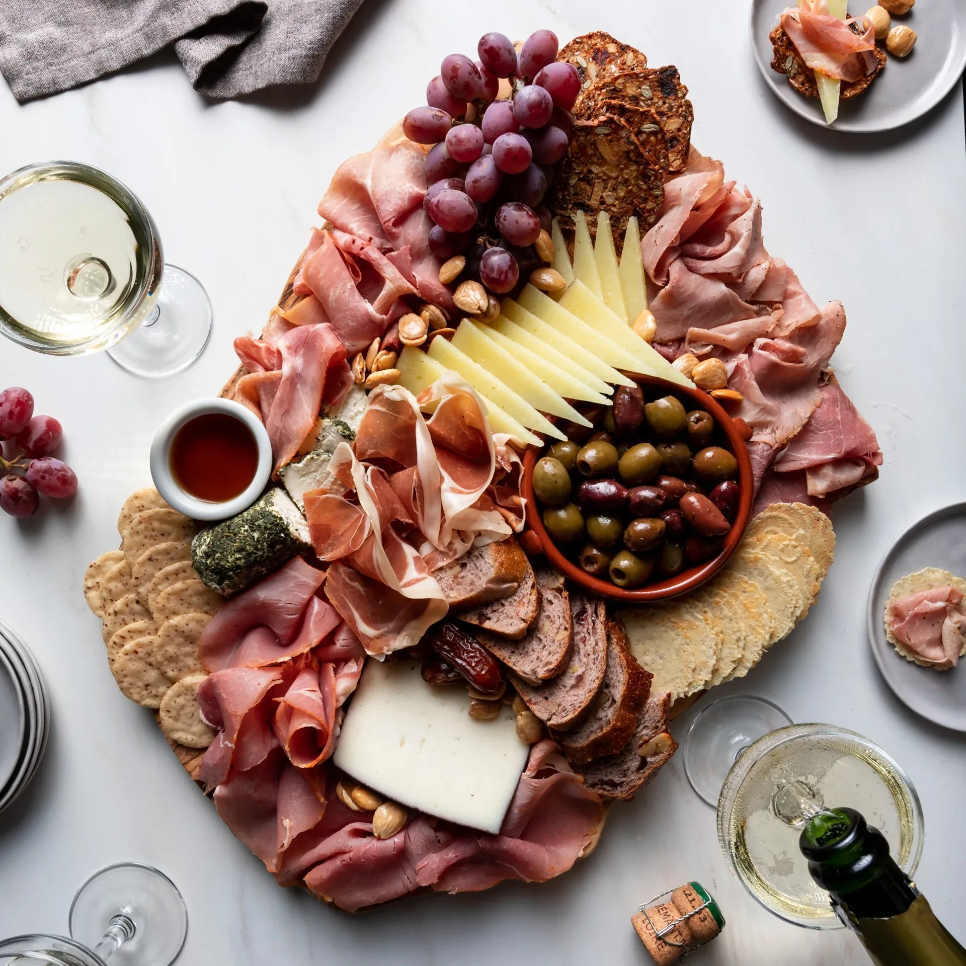 La Quercia jambon board with cured meats, cheese, grapes, olives and crackers