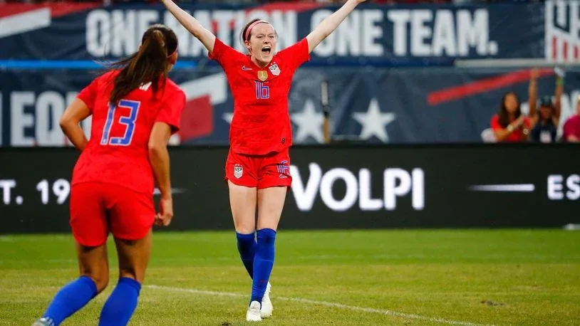 U.S. women’s national soccer team celebrating beside Volpi sponsorship signage